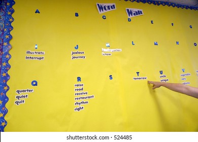 Teacher Sets Up The Yellow Word Wall For Her Students