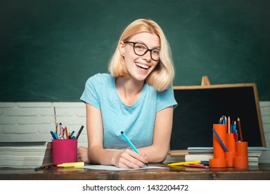 Teacher Is Skilled Leader. Young Teacher In Glasses Over Green Chalkboard Background. Beautiful Teacher In Classroom. Student Studying In The Classroom. World Teachers Day