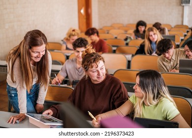 Teacher Solving Doubts Individually To Her Students In The University Class