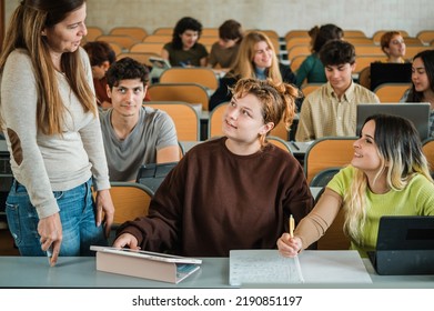 Teacher Speaking With Students During Lesson