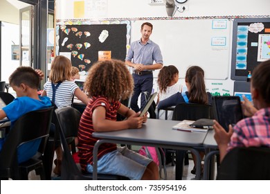 Teacher standing in front of elementary school class