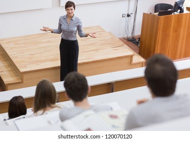 Teacher standing talking to the students at the lecture hall