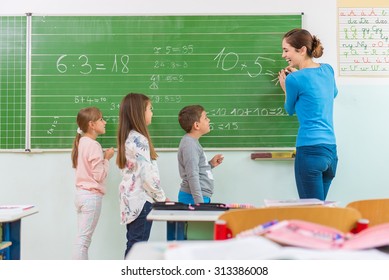 Teacher And Student At The Blackboard, Math Class