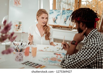 Teacher And Student. Blonde-haired Experienced Art Teacher Talking To Her Talented Student