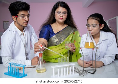 Teacher and student performing experiment in Chemistry lab
 - Powered by Shutterstock
