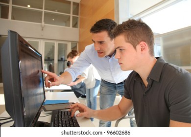 Teacher And Student Working On Computer