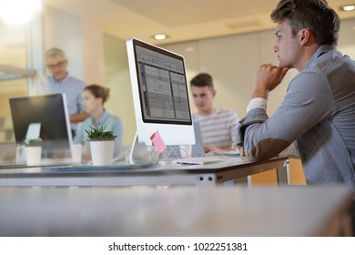 Teacher With Students In Apprenticeship Attending Computing Class