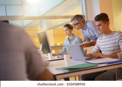 Teacher With Students In Apprenticeship Attending Computing Class