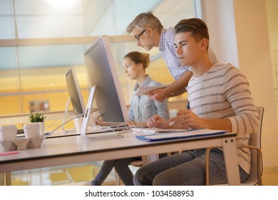 Teacher With Students In Apprenticeship Attending Computing Class