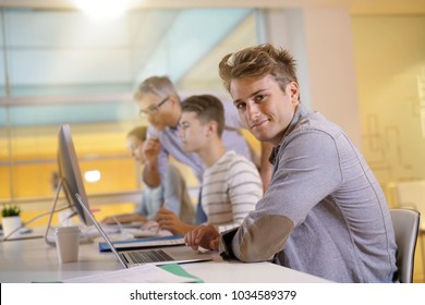 Teacher With Students In Apprenticeship Attending Computing Class