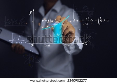 Teacher or students hands are graphing showing the integration in the calculus section of mathematics. is a function to find the area under the curved graph must use the integral.