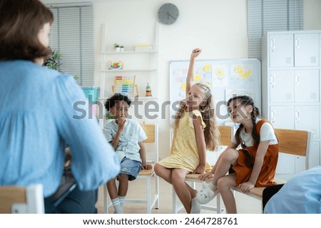 Teacher and students, Learn and study in a classroom of school where youngsters sit and listen attentively.