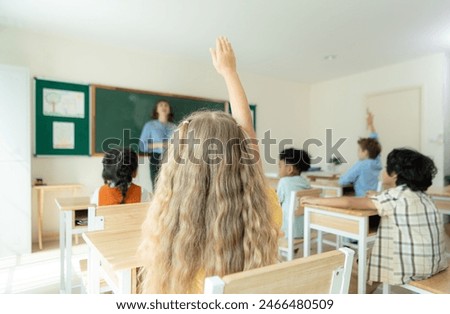 Teacher and students, Learn and study in a classroom of school where youngsters sit and listen attentively.