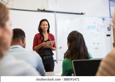 Teacher With Tablet And Students At An Adult Education Class