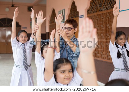 Teacher Taking Exercise Class In School