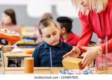 A Teacher Teaching An Elementary Student Shapes At Geometry Class.