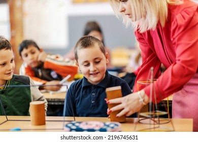 A Teacher Teaching An Elementary Student Shapes At Geometry Class.