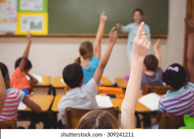 Teacher teaching a lesson in class at the elementary school - Shutterstock ID 309241211