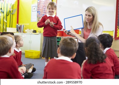 Teacher Teaching Spelling To Elementary School Pupils