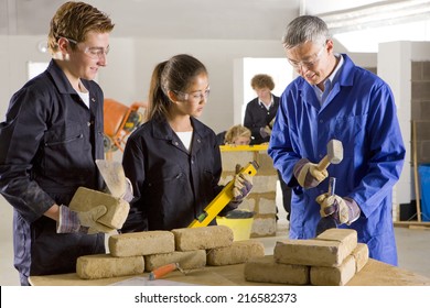 Teacher Teaching Students Bricklaying In Vocational School