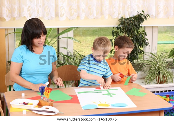 Teacher Two Preschoolers Making Some Decoration Stock Photo (Edit Now