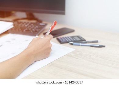 Teacher Use A Red Pen Check Example Sheet And Examination  Equipment On The Wood Table And Use Desktop Computer Working 