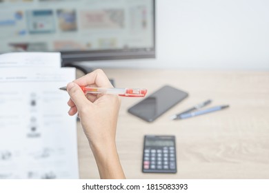 Teacher Use A Red Pen Check Example Sheet And Examination  Equipment On The Wood Table And Use Desktop Computer Working In The Background