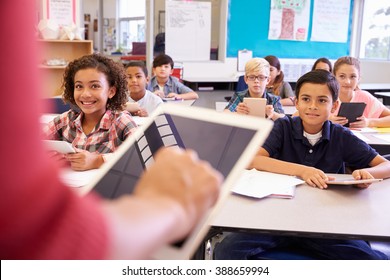 Teacher using tablet computer in elementary school lesson