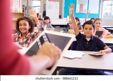 Teacher using tablet computer in elementary school lesson - Powered by Shutterstock