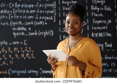 IT teacher using tablet pc at lesson