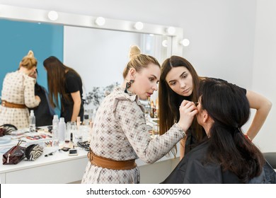 Teacher Visagiste With Her Student Girl Applying Makeup On The Eyes At Master Class In Beauty School