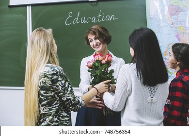 Teacher Woman Happy Young Students Who Are Giving Flowers To Her In Class