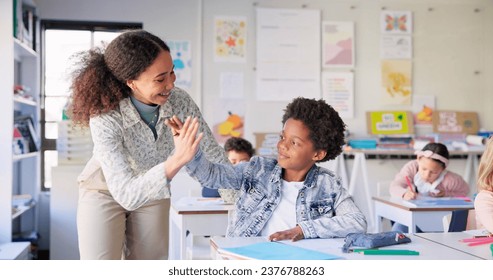 Teacher woman, high five boy and classroom with achievement, success and mentorship for learning. Education, development and students with goals, knowledge and books with celebration, school and desk