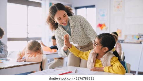 Teacher woman, high five girl and classroom with achievement, success and mentorship for learning. Education, development and students with goals, knowledge and books with celebration at school desk