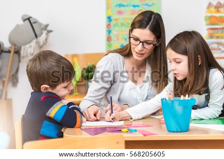 Teacher Working with Children in Preschool Classroom