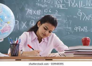 Teacher Working At Desk