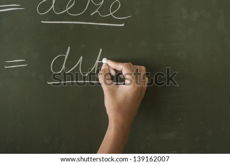 teacher writing on blackboard