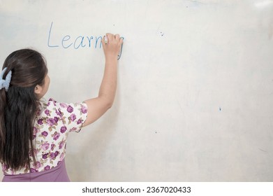 the teacher is writing on the board - Shutterstock ID 2367020433