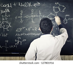 Teacher Writing On Classic Blackboard