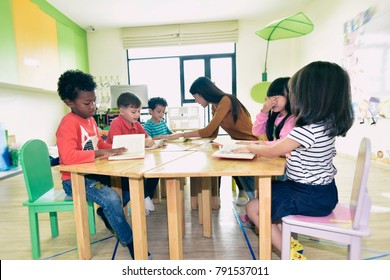 Teachers and children having fun on learning in an international school .teacher ,education, kid and primary school concept .