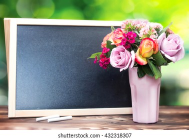 Teacher's day background.Black chalk board frame empty copy space and fresh flowers in vase.Holiday feminine  poster.Spring greeting 8 march icon. - Powered by Shutterstock