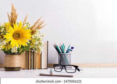 Teacher's day holiday greeting icon. Education knowledge day concept. Wooden chalk board frame and vase bouquet on table empty copy space. - Powered by Shutterstock