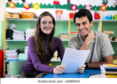 Teachers or teacher and parent having a discussion in classroom