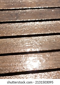 Teak Boards Of A Terrace Table Wet From The Rain. Outdoor Furniture Texture. 