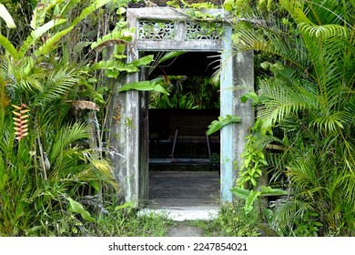 A teak Javanese door as the entrance to the restaurant. Tropical vibes. - Shutterstock ID 2247854021
