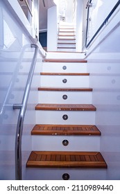 Teak steps with handrails on a luxury yacht. Teak deck of the yacht. Entrance to the second floor of the yacht.