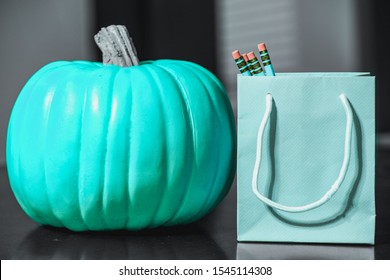 Teal Blue Pumpkin And Pencils In A Teal Bag For Kids With Food Allergies.