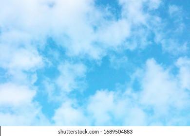 Teal Blue Sky With Puffy Clouds, An Abstract Background