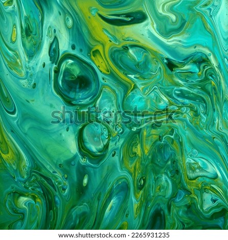 Teal green and yellow abstract fluid art background of acrylic paint, with marbling effect, colorful bubbles and copy space
