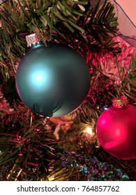 Teal And Red Christmas Ornaments At Night